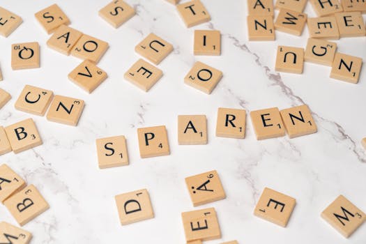 Scrabble tiles scattered on a marble surface depicting creativity and wordplay.