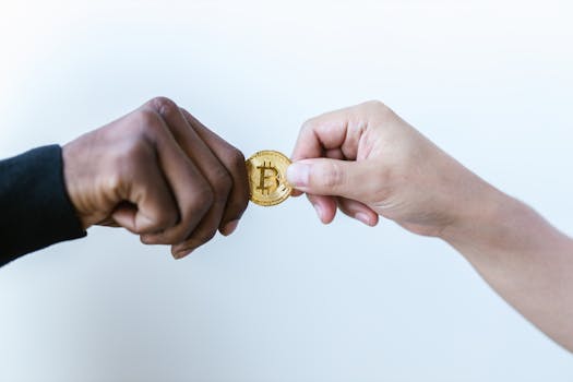 Two hands exchanging a Bitcoin coin, symbolizing cryptocurrency transactions.