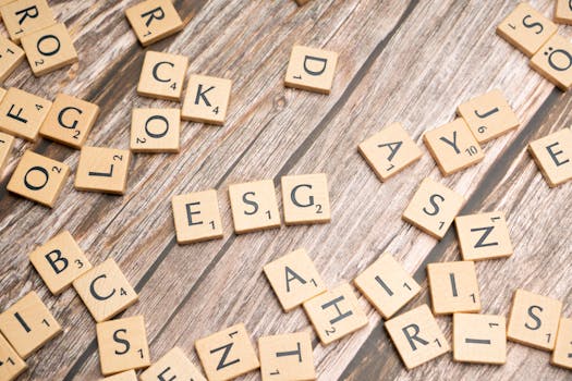 Wooden letter tiles spell ESG on a rustic wooden surface, emphasizing sustainability.